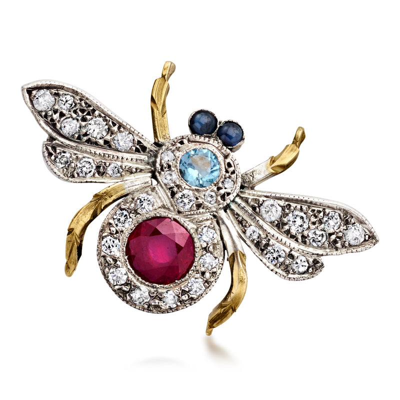 Bee-shaped gemstone pin with blue and red stones and diamond accents, gold-and-silver setting