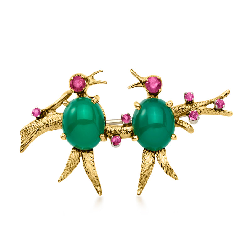 Gold-tone birds pin with green oval stones and pink ruby accents, curved wings