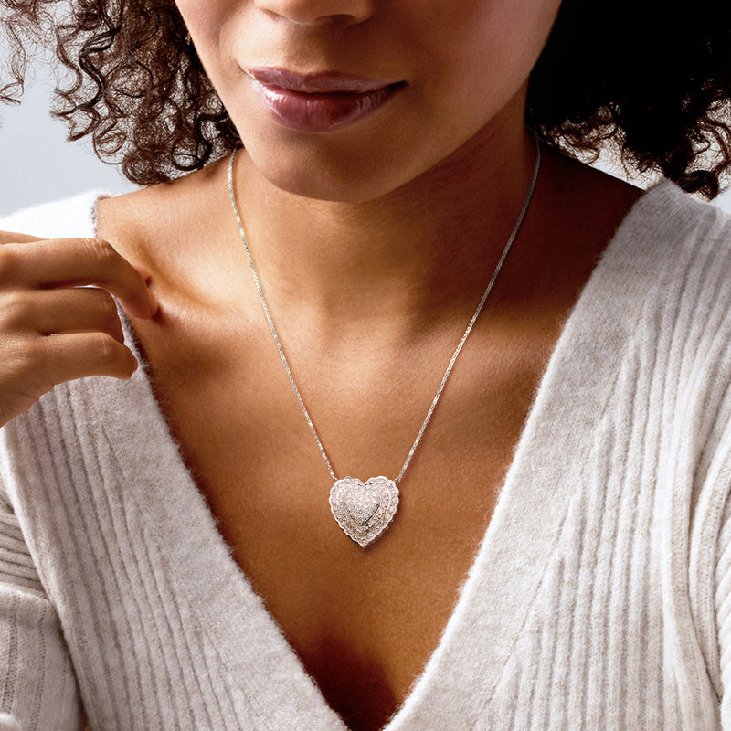 Platinum heart diamond pendant necklace on a delicate chain near neckline