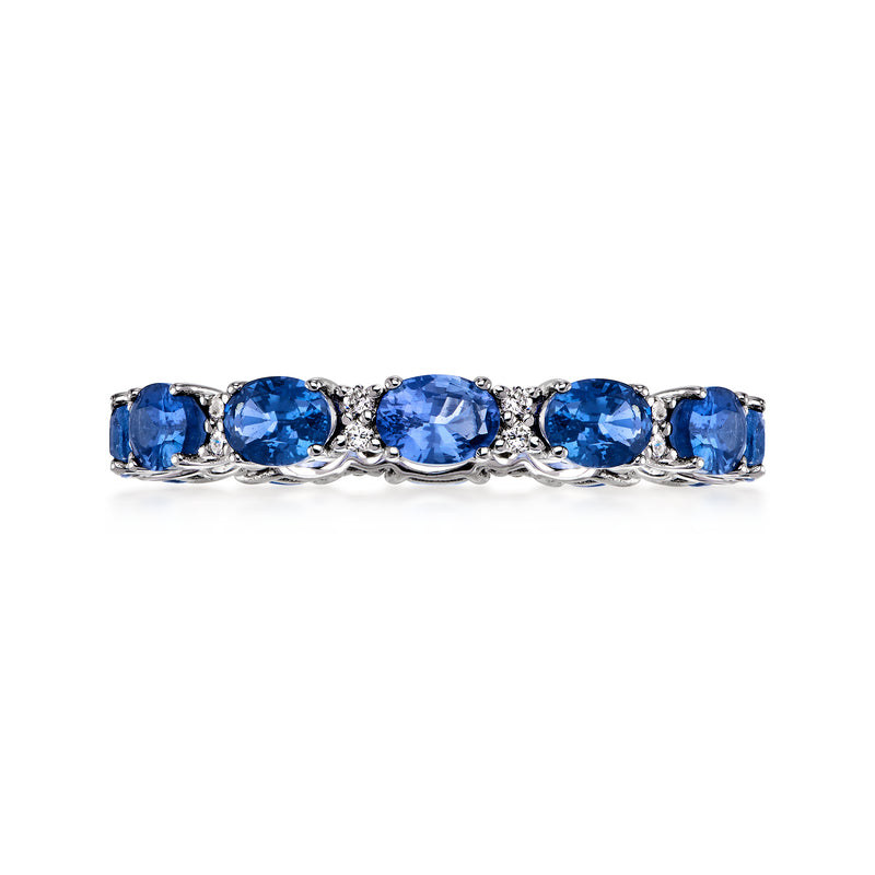 14kt white gold eternity band with oval blue sapphires and small diamond accents