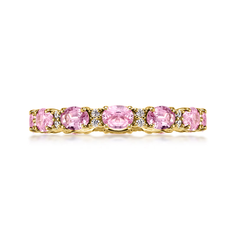 Pink sapphire eternity band in 14kt yellow gold with diamond accents, oval stones