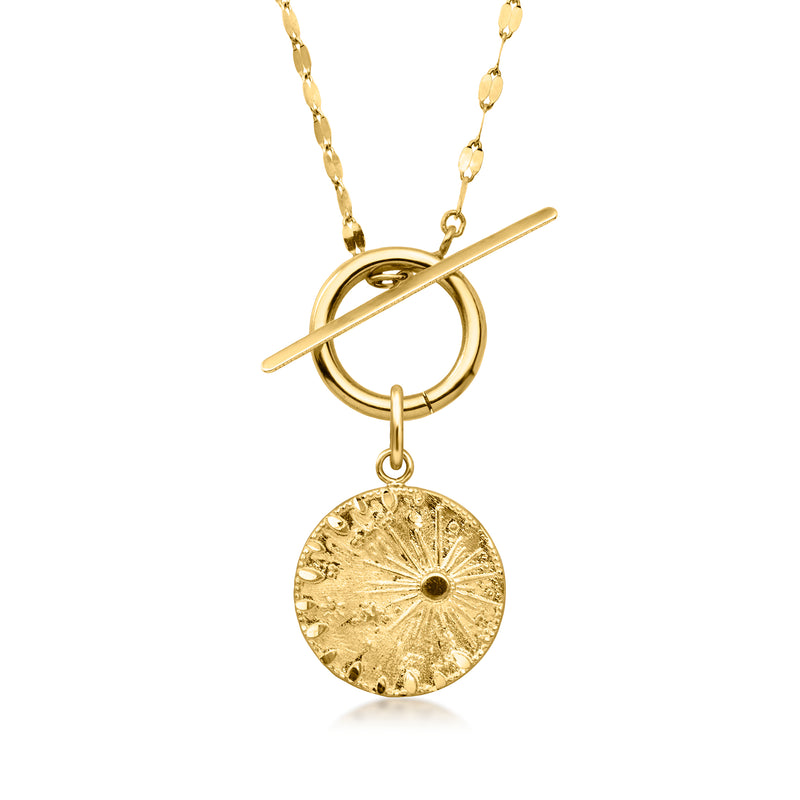 Yellow gold celestial charm pendant with sunburst design on a layered necklace