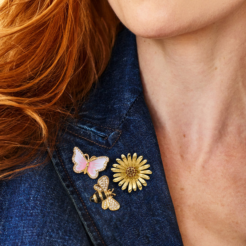 Gold-plated enamel pin set on denim: pink butterfly, gold daisy flower, bee with gems