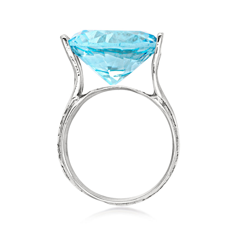 Sterling silver ring with teardrop simulated blue topaz in open prong setting