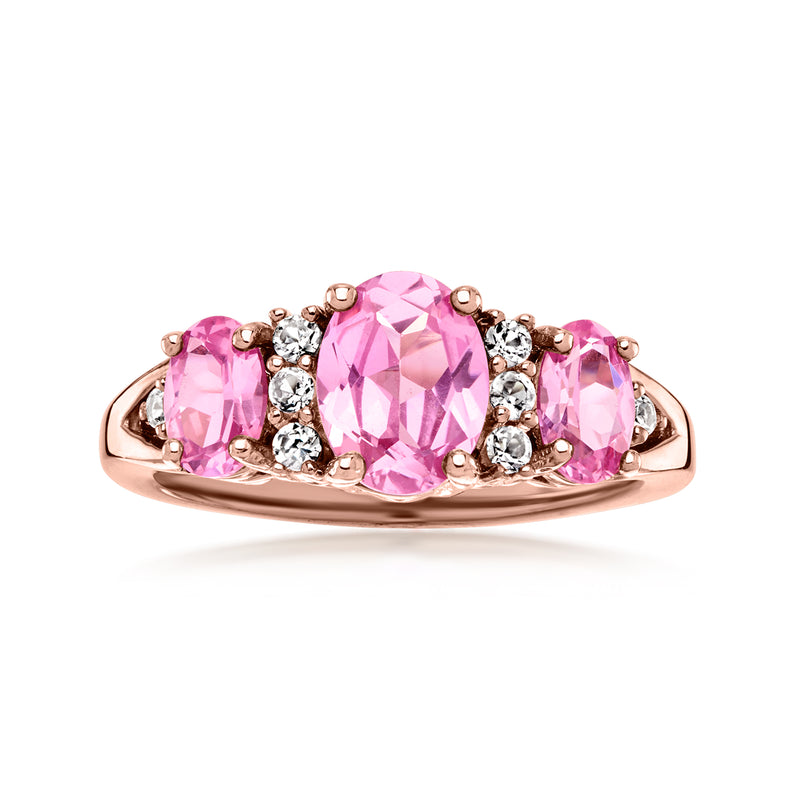 Rose gold ring with oval pink center CZ flanked by pink stones and white accents