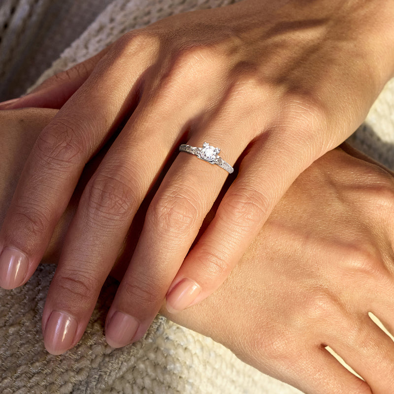 Solitaire diamond ring in 18kt white gold on hand, round center stone