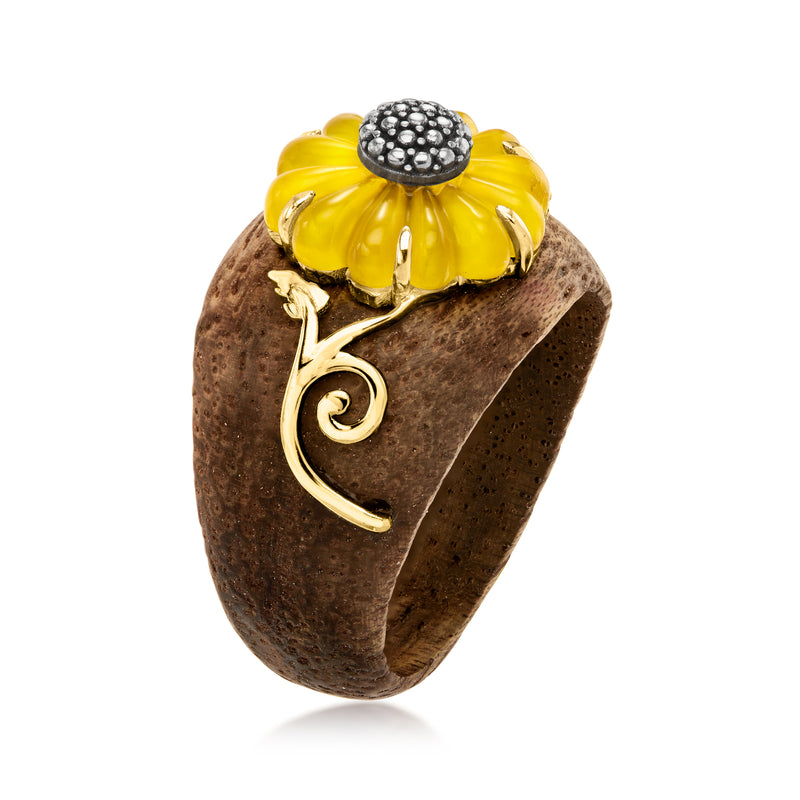 Sunflower ring with yellow cabochon petals and dark center on textured dark wood-look band