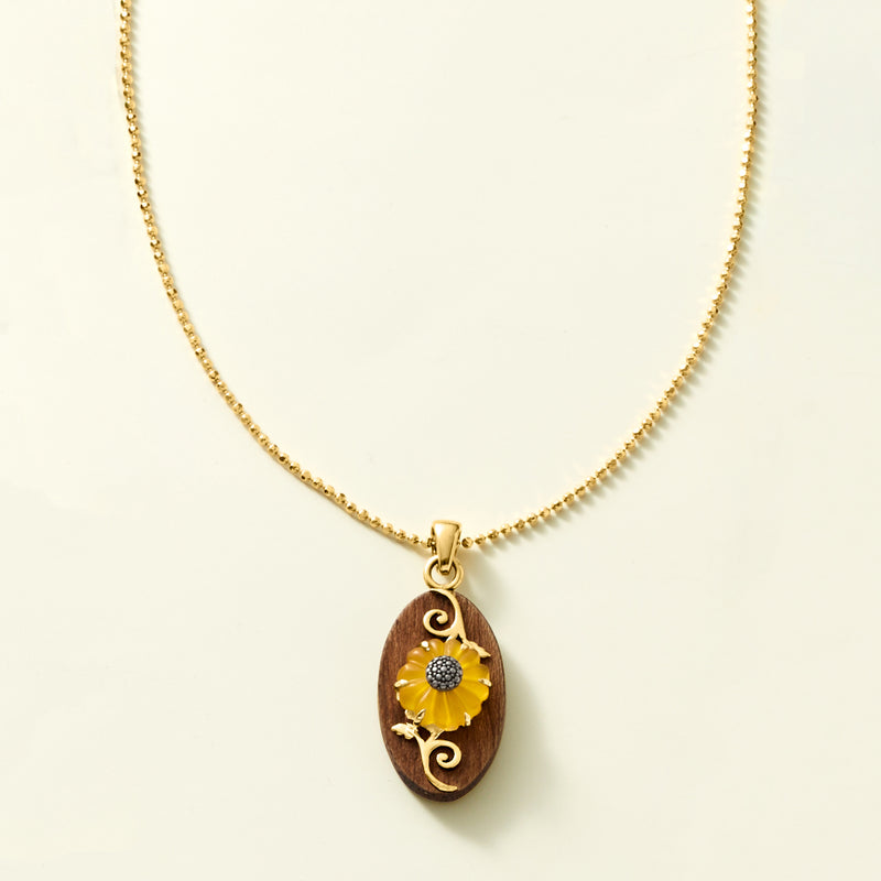 Gold-tone chain necklace with oval wooden sunflower pendant and yellow center stone