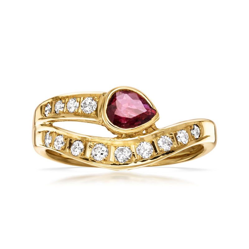 18kt yellow gold bypass ring with oval ruby center and round diamond accents