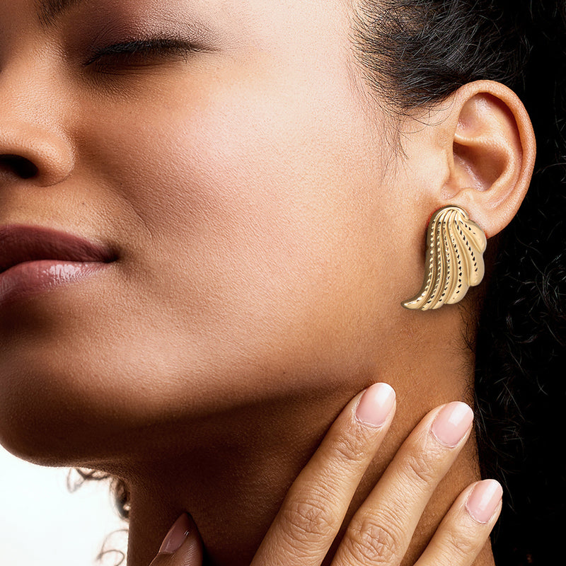 Winged yellow gold post earrings on model, close-up of scalloped fan design