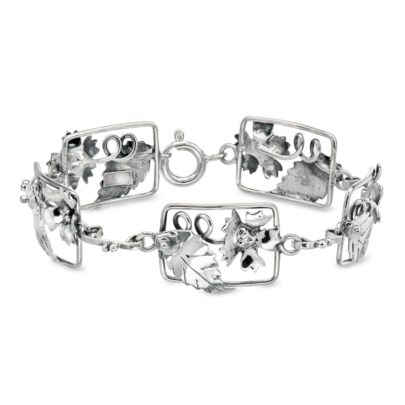 Vintage sterling silver open-link bracelet with rectangular floral charms and hinged links