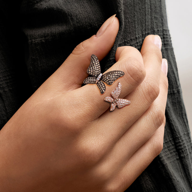 Butterfly ring with pavé brown and white stones, shown on a hand