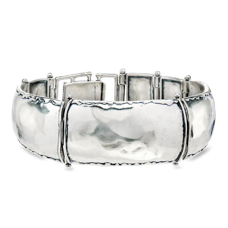 Sterling silver wide link bracelet with textured hinged links and centerpiece panel
