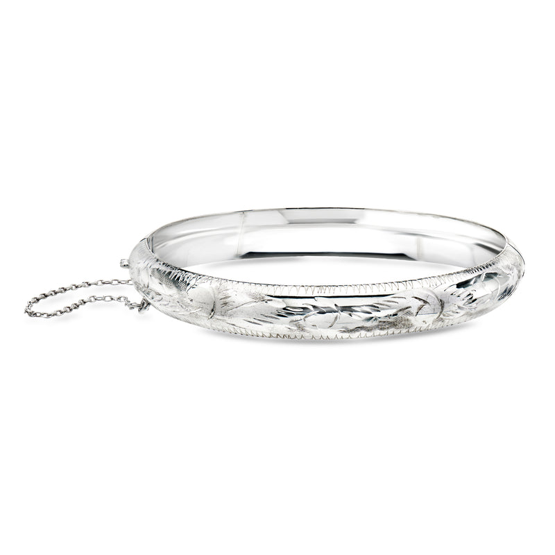 Etched sterling silver bangle bracelet with textured detailing and small attached chain