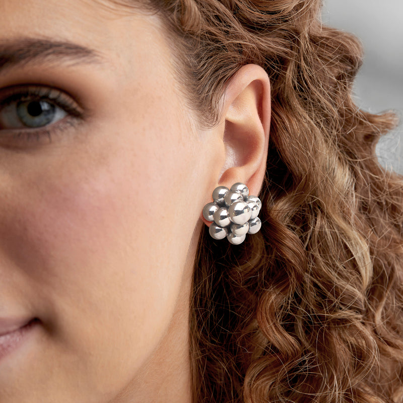 Sterling silver bubble earrings on model ear, clustered round beads with shiny finish