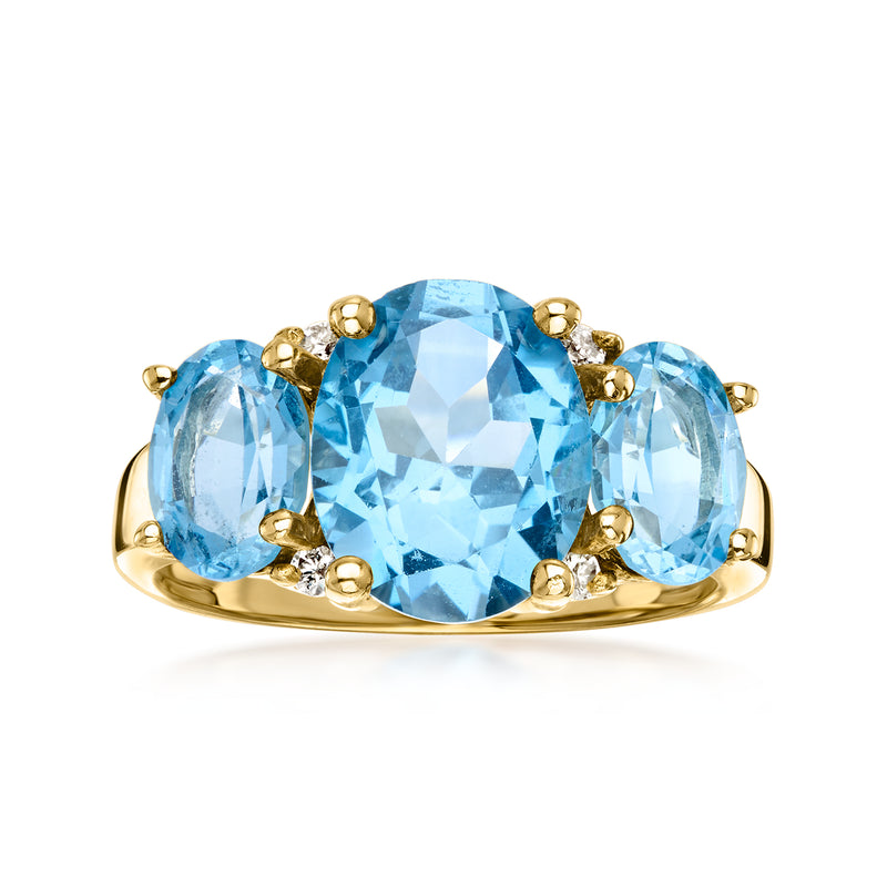 Vintage yellow gold ring with large blue oval topaz and small diamond accents