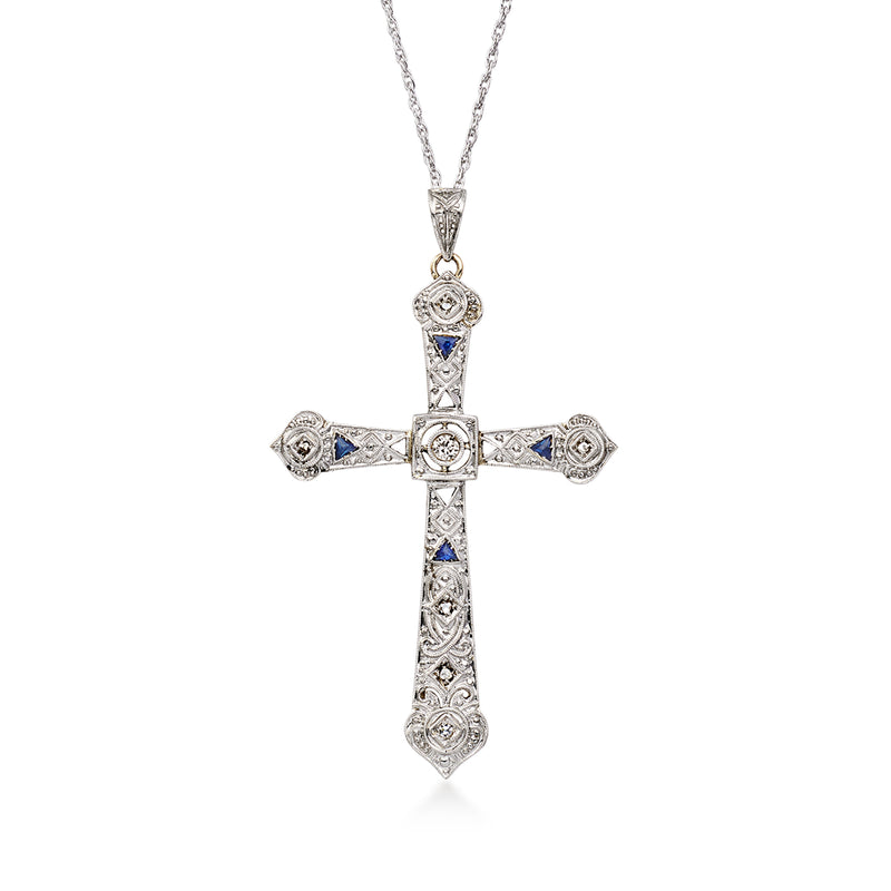 Vintage cross pendant necklace with filigree links and blue stone accents on platinum chain