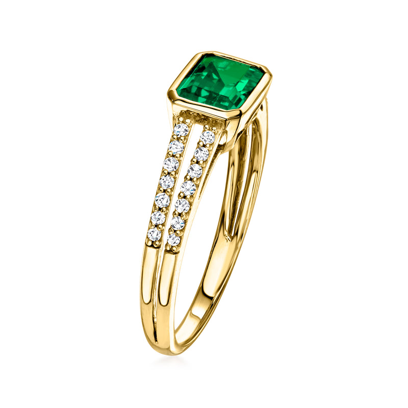 Yellow gold ring with emerald-cut green stone and row of diamond accents