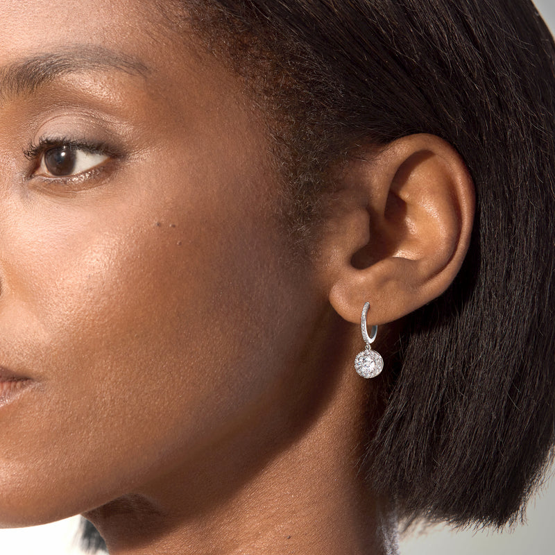 Sterling silver hoop drop earrings with round diamond cluster dangle, side view