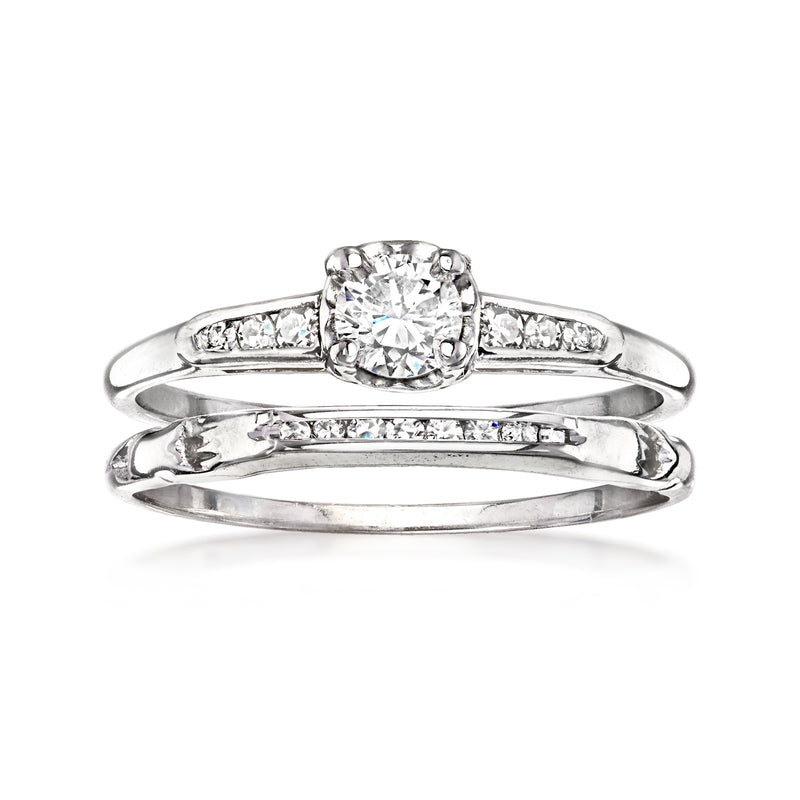 Two stacked white gold diamond bridal rings, round center stone with side accents