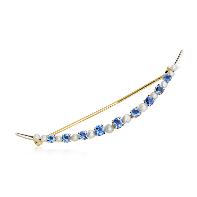 Curved pin brooch with cultured pearls and oval blue sapphire stones in gold