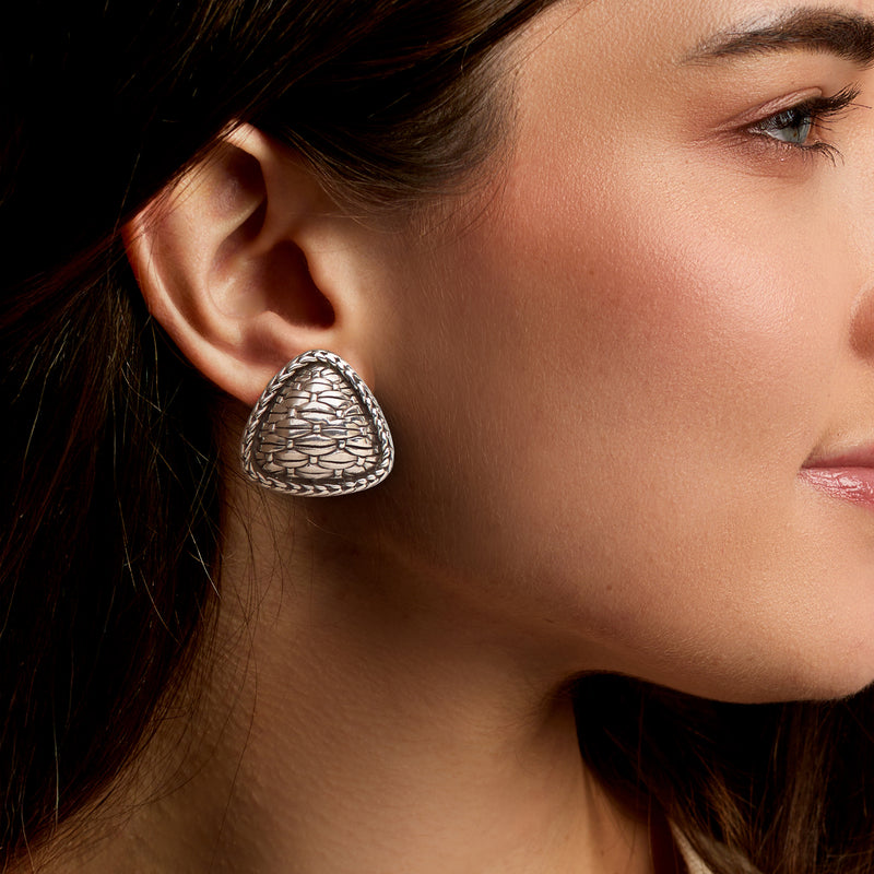 Triangular sterling silver clip-on earrings shown on ear with basketweave pattern