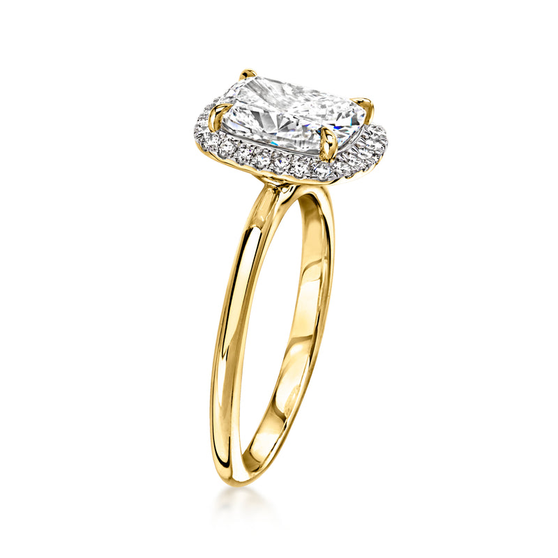 Yellow gold diamond ring with cushion-cut center stone and full halo, side view