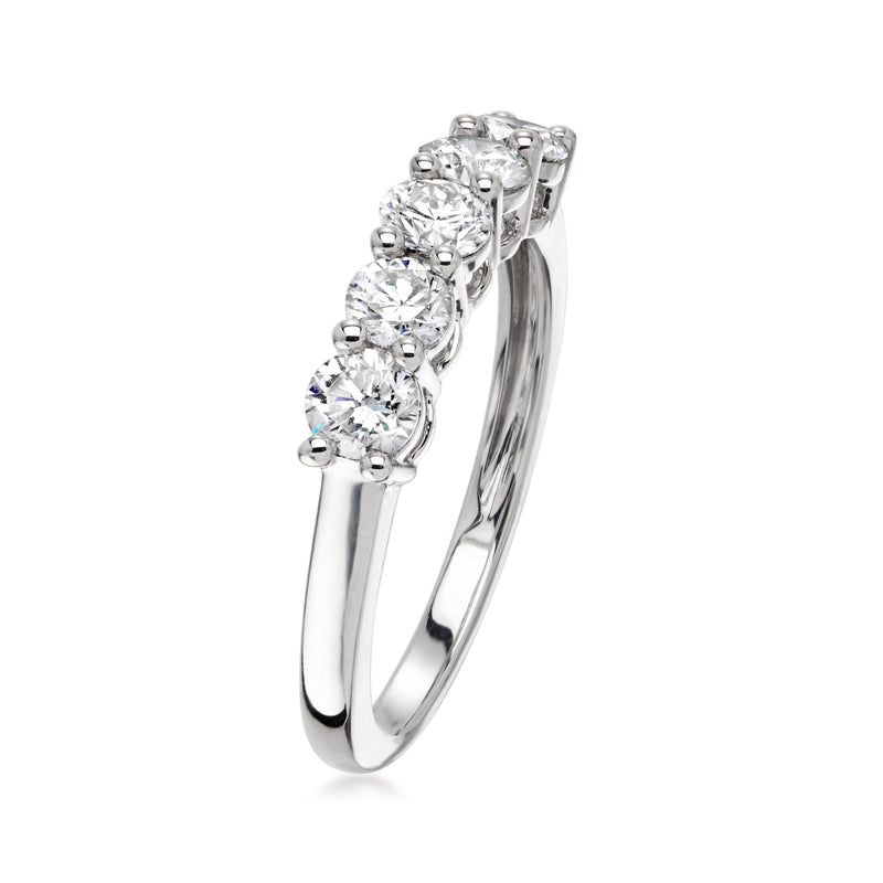 Sterling silver diamond ring, side view of round prong-set stones on curved band