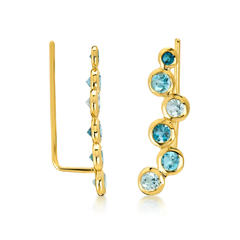 Gold ear climber earrings, side view, with round blue topaz in linked row