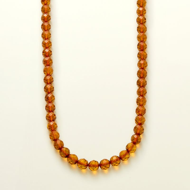 Amber bead necklace with faceted orange beads, single-strand design