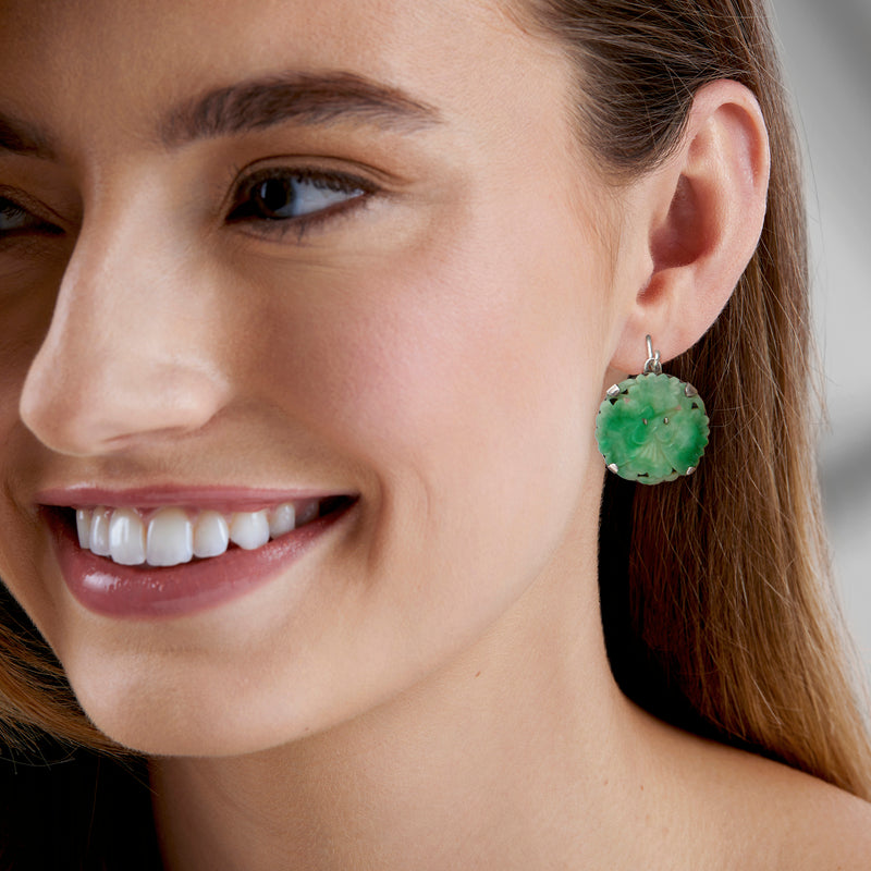 Green carved jade drop earring on sterling silver earwire, worn by model