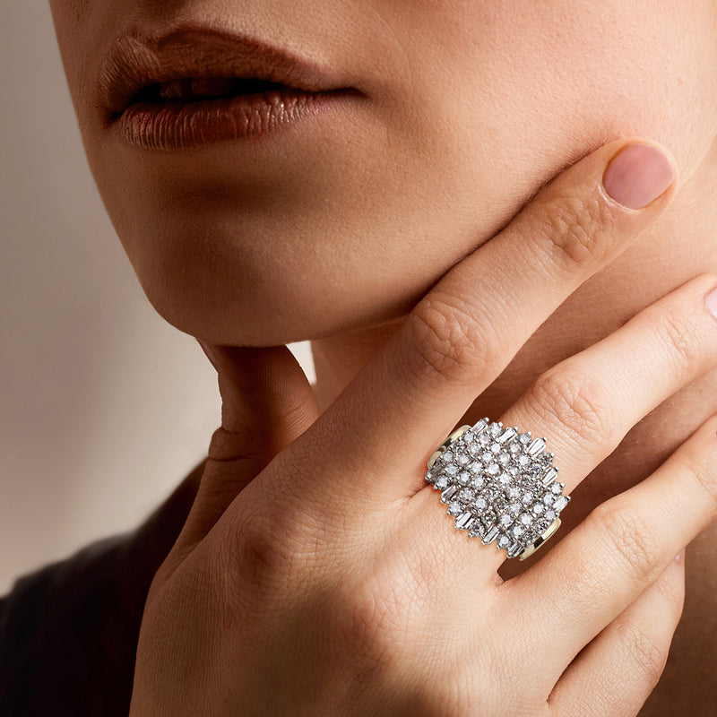 Diamond cluster ring on finger, silver-toned stones with textured prong setting