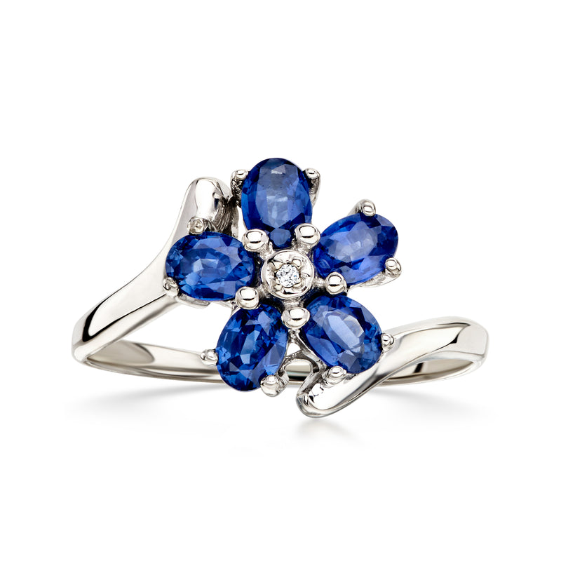 Blue sapphire flower ring with diamond center in 14k white gold, oval side prongs