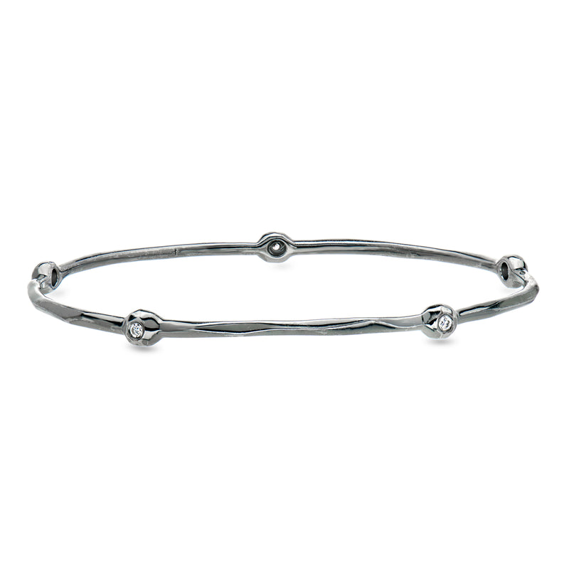 Sterling silver bangle bracelet with round diamond station accents