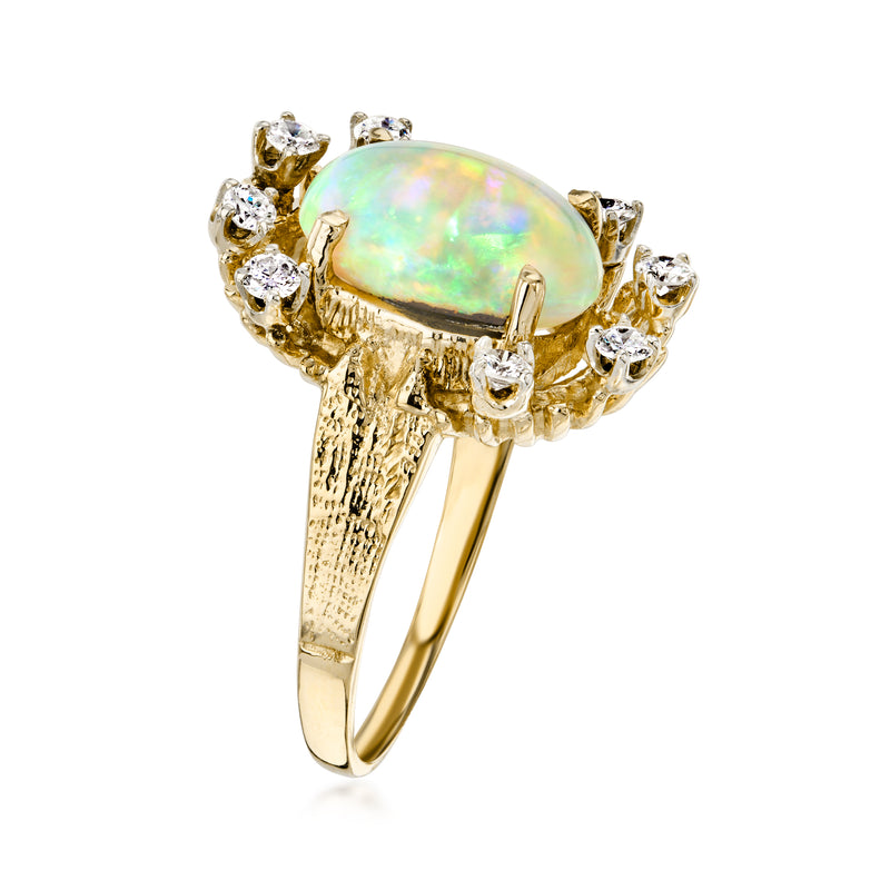 Oval opal ring with round diamond accents, yellow gold prong setting, side view