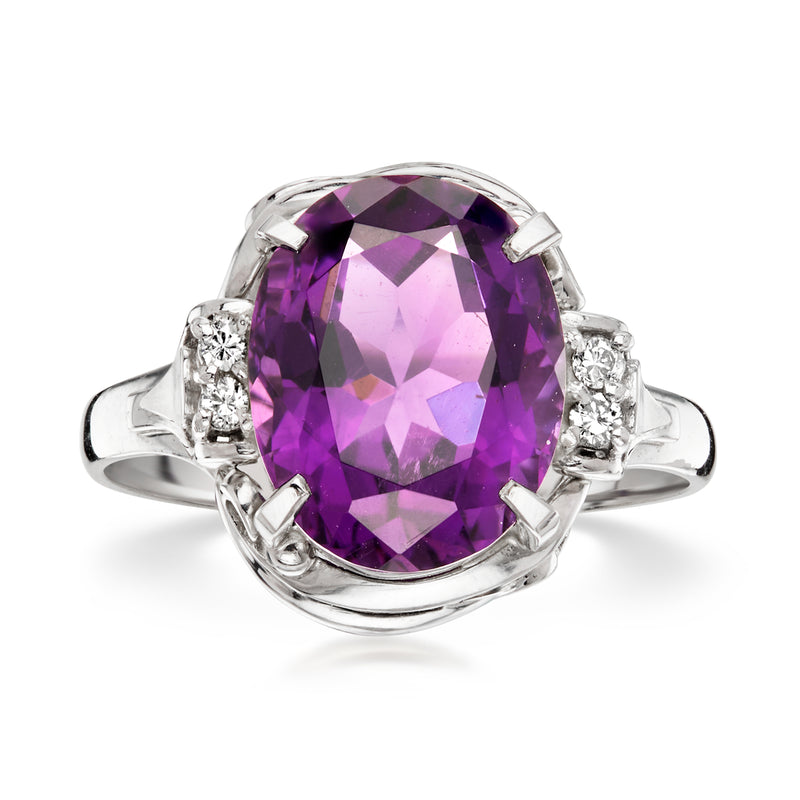 Platinum ring with large oval amethyst and diamond side stones, vintage-style setting