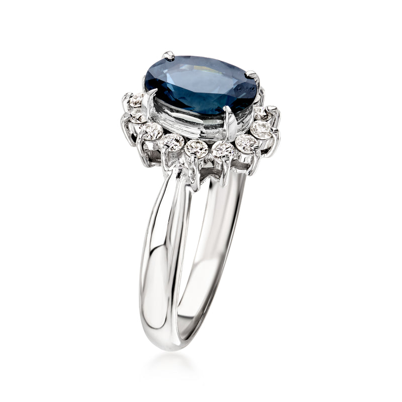 Platinum ring featuring an oval blue sapphire with diamond accents on the band