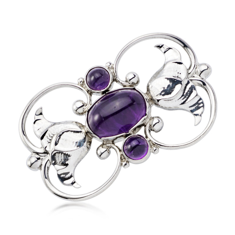 Sterling silver amethyst gemstone pin with oval center stone and three purple accents