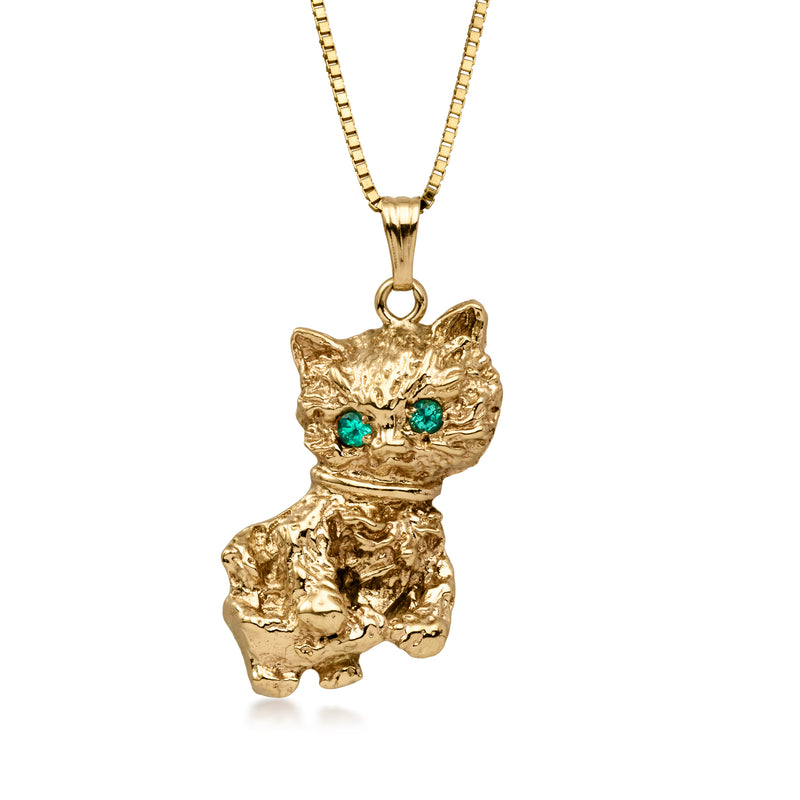 Gold cat pendant necklace with emerald eyes on a thin chain