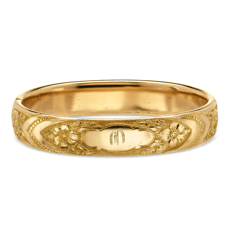 Gold-filled floral etched bangle bracelet with engraved oval panel and scalloped edge