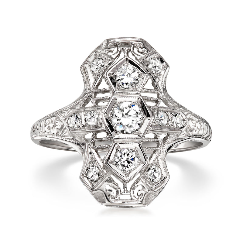 Vintage white gold diamond dinner ring with geometric bezel and round center stone