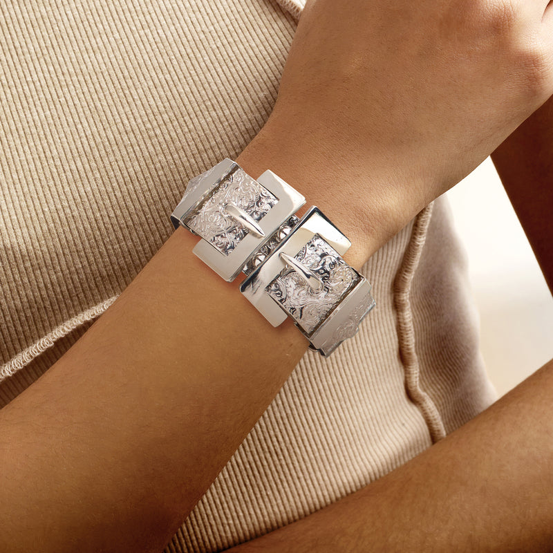 Sterling silver buckle bangle bracelet on wrist with engraved square links