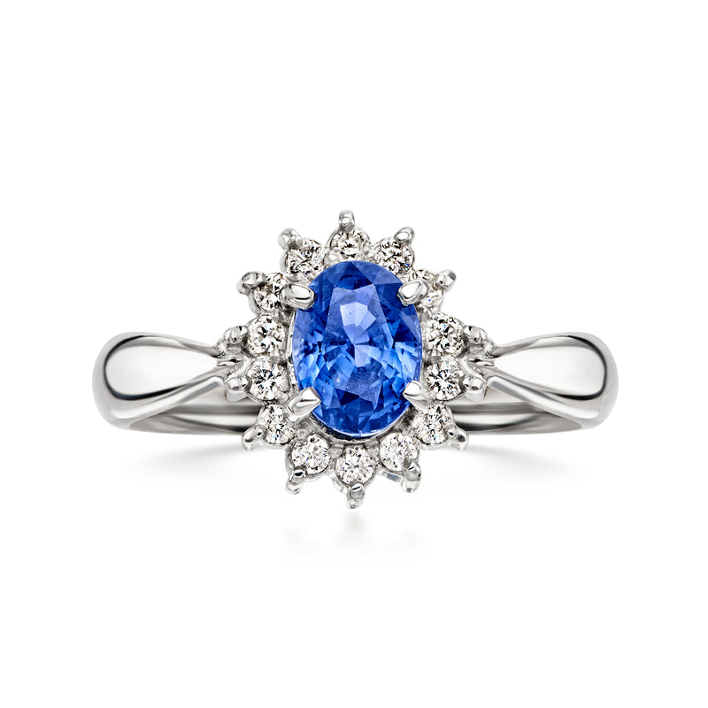 Platinum sapphire and diamond ring with oval blue center stone and halo