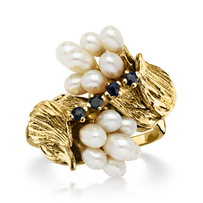 C. 1960 Vintage Cultured Oval Pearl and .12 ct. t.w. Sapphire Flower Bypass Ring in 14kt Yellow Gold. Size 7