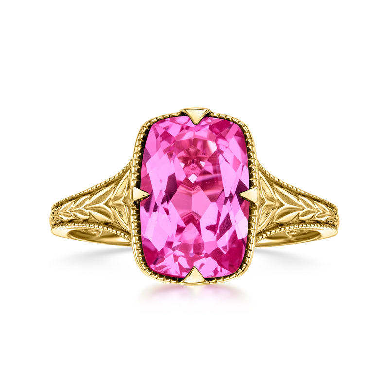 10kt yellow gold ring with large pink oval lab-grown sapphire and filigree shank