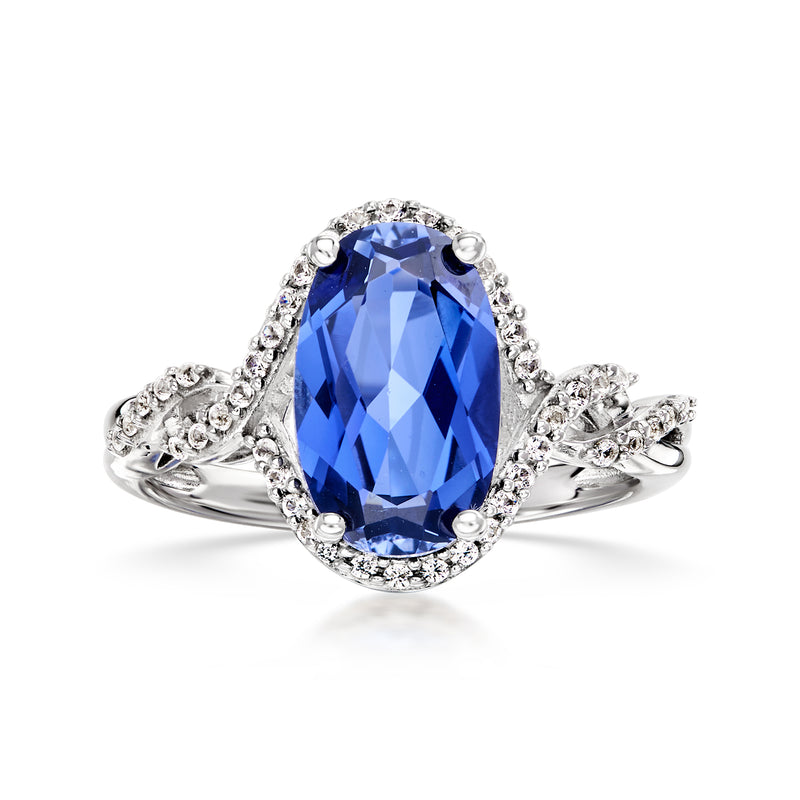 Sterling silver ring with oval blue sapphire and diamond halo, side prong settings