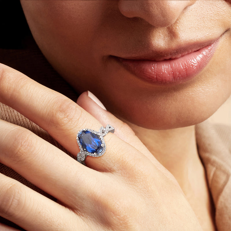 Sterling silver lab-grown sapphire ring with white sapphires on hand