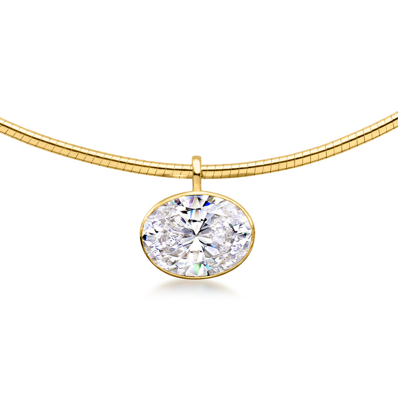 Gold-tone oval CZ pendant with round bezel and chain bail