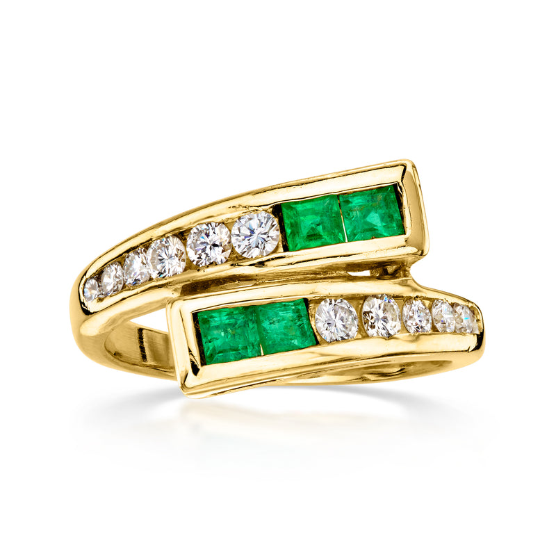 C. 1980 Vintage .55 ct. t.w. Diamond and .40 ct. t.w. Emerald Bypass Ring in 18kt Yellow Gold. Size 6.75