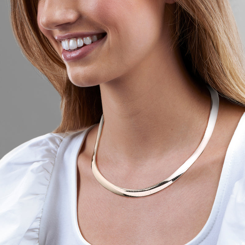 Sterling silver omega chain necklace on model, ribbed links with smooth clasp